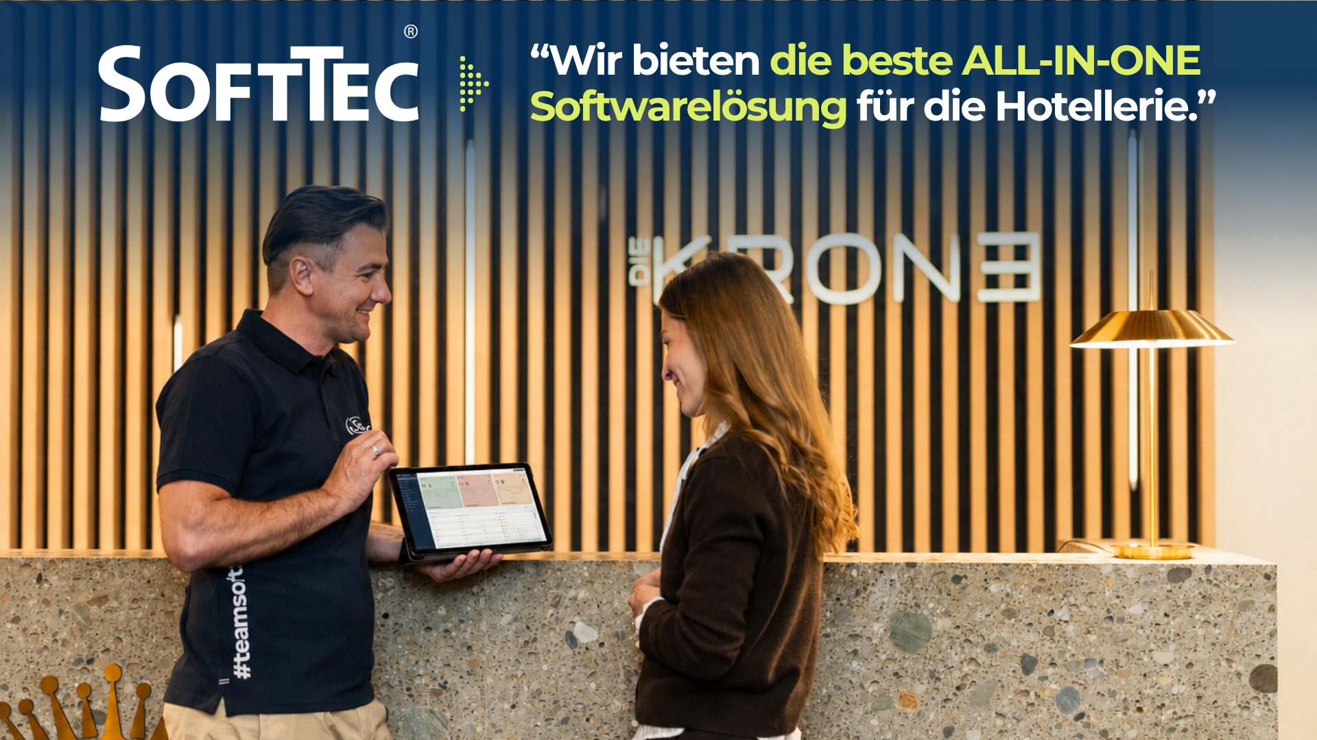Leitsatz der SoftTec GmbH: Wir bieten die beste All-in-one Softwarelösung für die Hotellerie. SoftTec Mitarbeiter berät eine Hotelmitarbeiterin an der Rezeption mit der SoftTec Hotelsoftware auf dem Tablet.